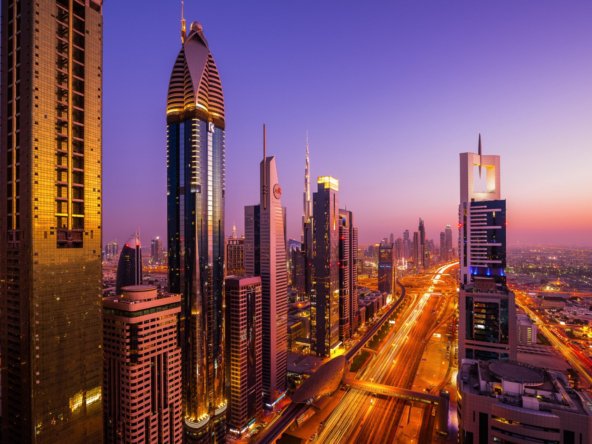 Dubai skyline at sunset with city lights and modern buildings