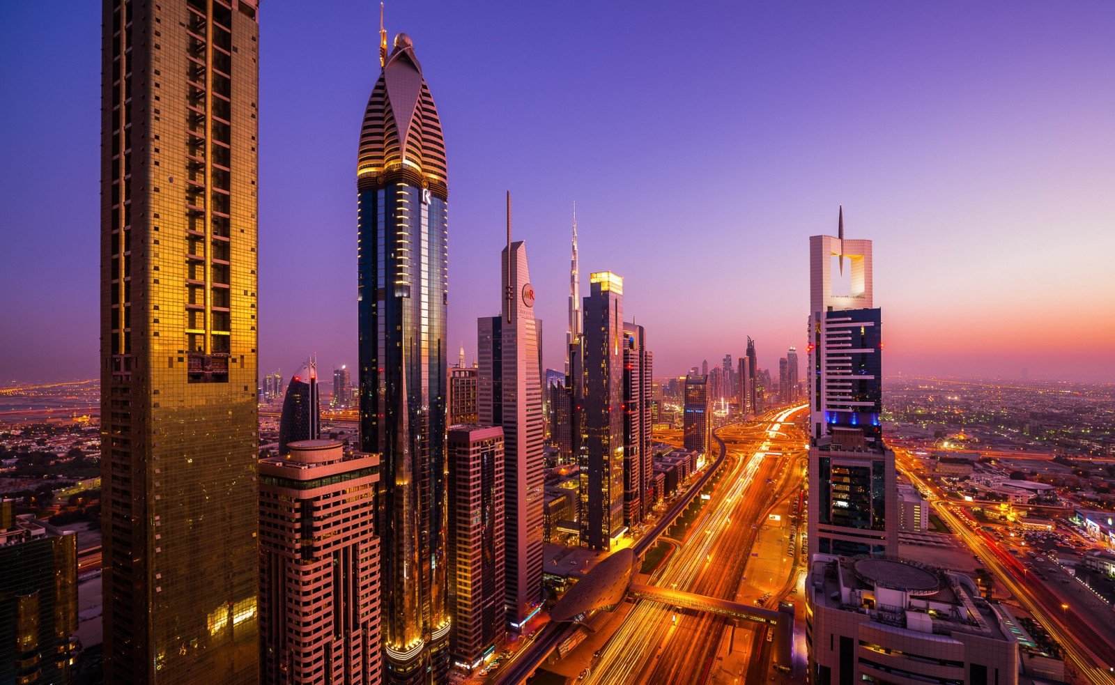 Dubai skyline at sunset with city lights and modern buildings